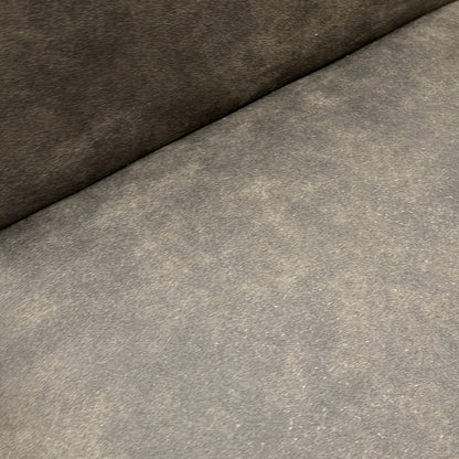 Close-up detail of the grey "Cowboy" suede fabric, showing the texture and stitching on the upholstered back of the Augusta chair.