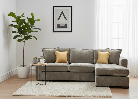 Gray sectional sofa with gold pillows in a living room setting.