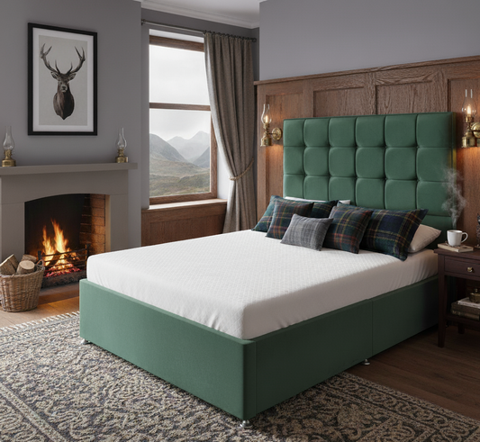 Green upholstered bed in a room with a fireplace and mountain view