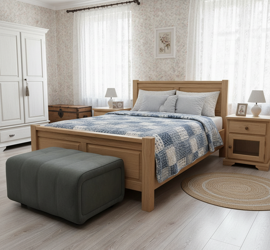 Bedroom with wooden bed, ottoman, and side tables.