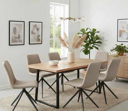Dining room with a wooden table and beige chairs, featuring a vase and plants.