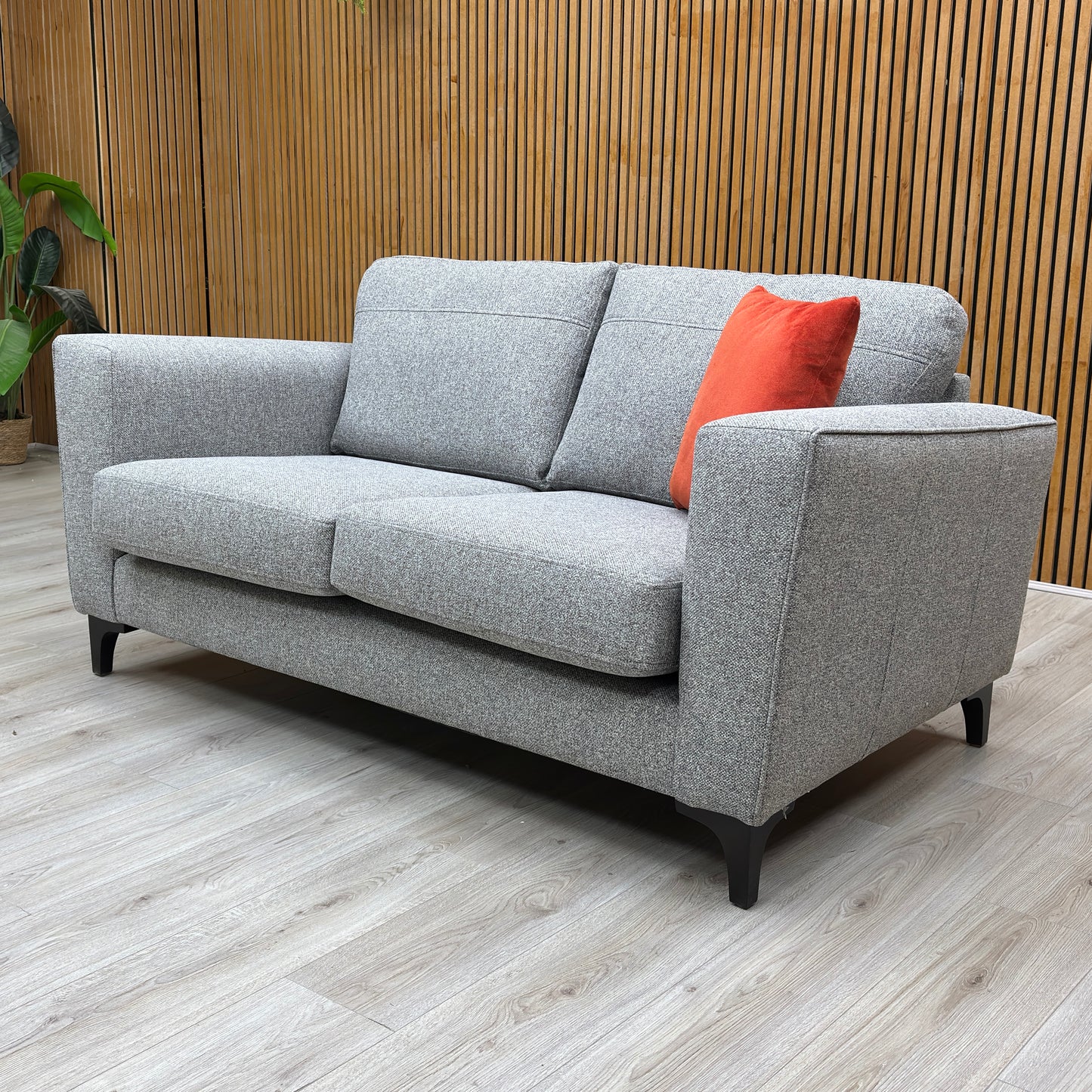 Lifestyle shot of the ‘Lille’ silver fabric sofa, showcasing the structured cushions and silver grey fabric.