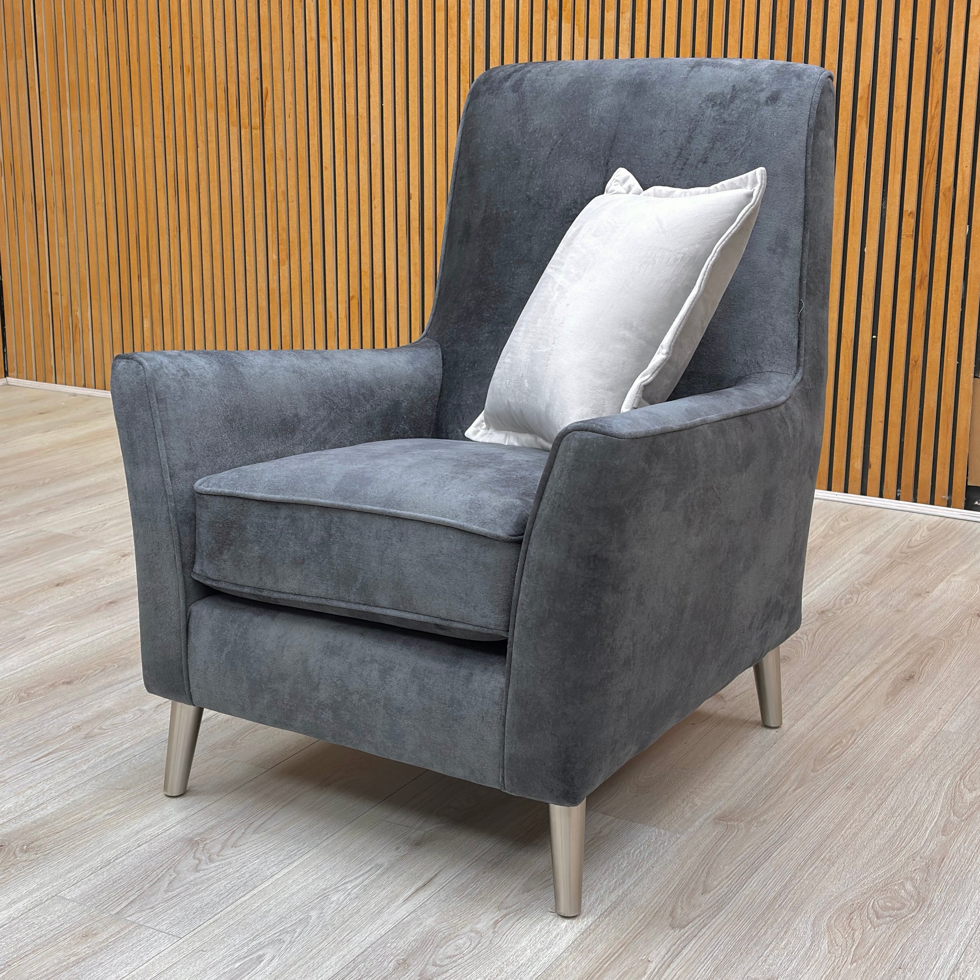 Lifestyle arrangement featuring the ‘Collins’ accent chair as a statement piece in a contemporary living room.