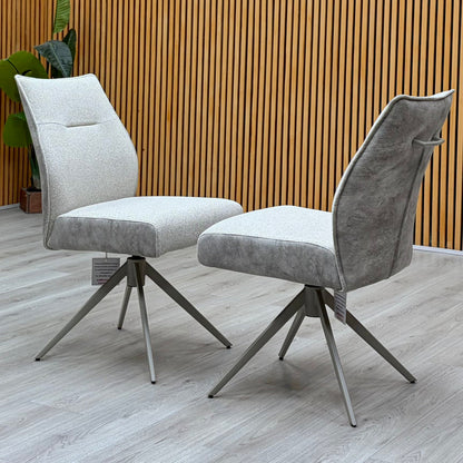 Mirage neutral fabric swivel dining chair pair against a slatted wooden wall on a light oak floor