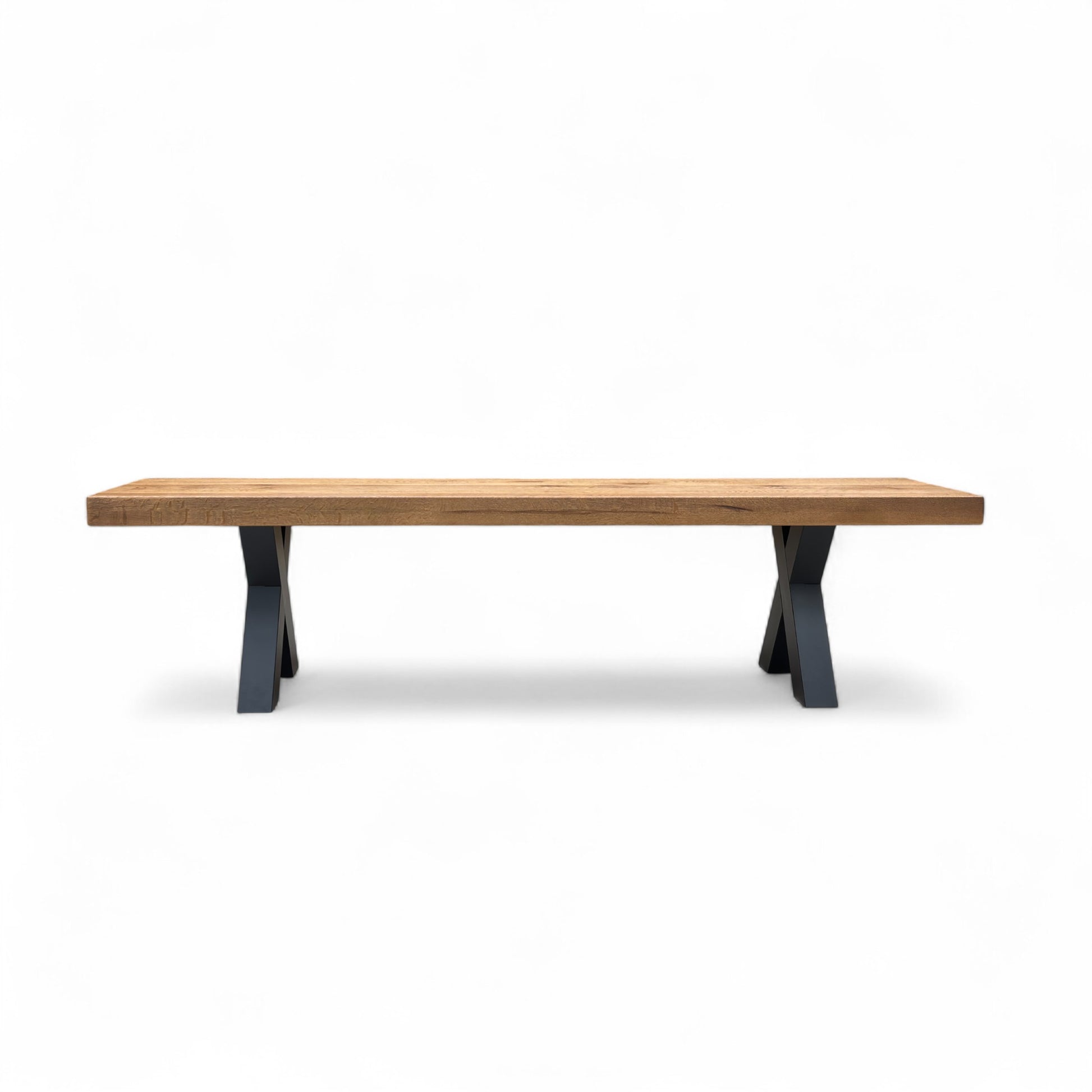 The Bodahl Njord Oak Dining Bench shown in a dining room setting, paired with a matching table and chairs to illustrate scale.