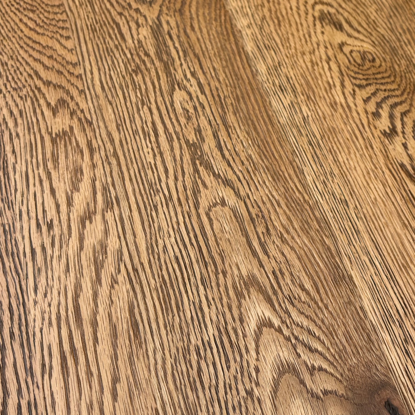 Close-up of the Desert Solid Oak seating surface, highlighting the natural grain, texture, and rustic finish of the wood.