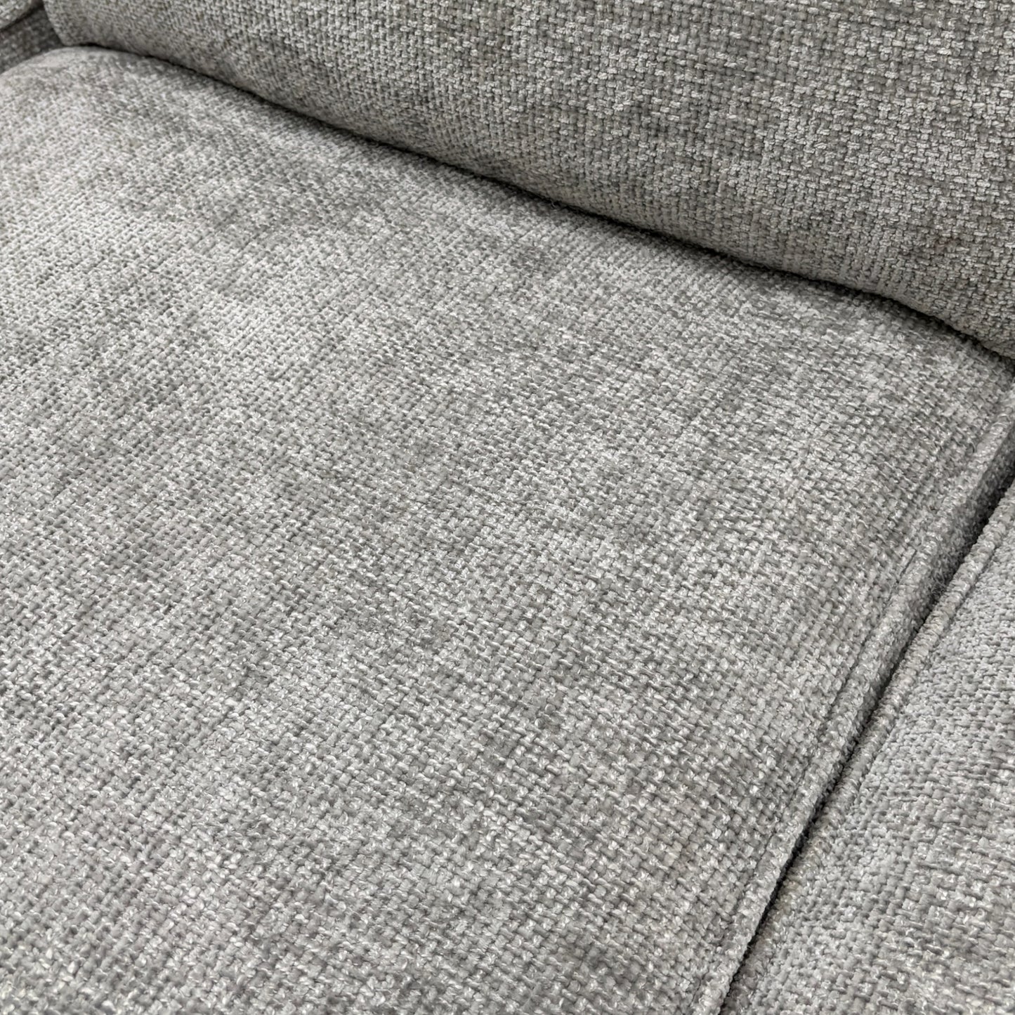 Close-up of the silver woven fabric, showing the fine texture and color of the 'Emilia' Corner Sofa Bed upholstery.