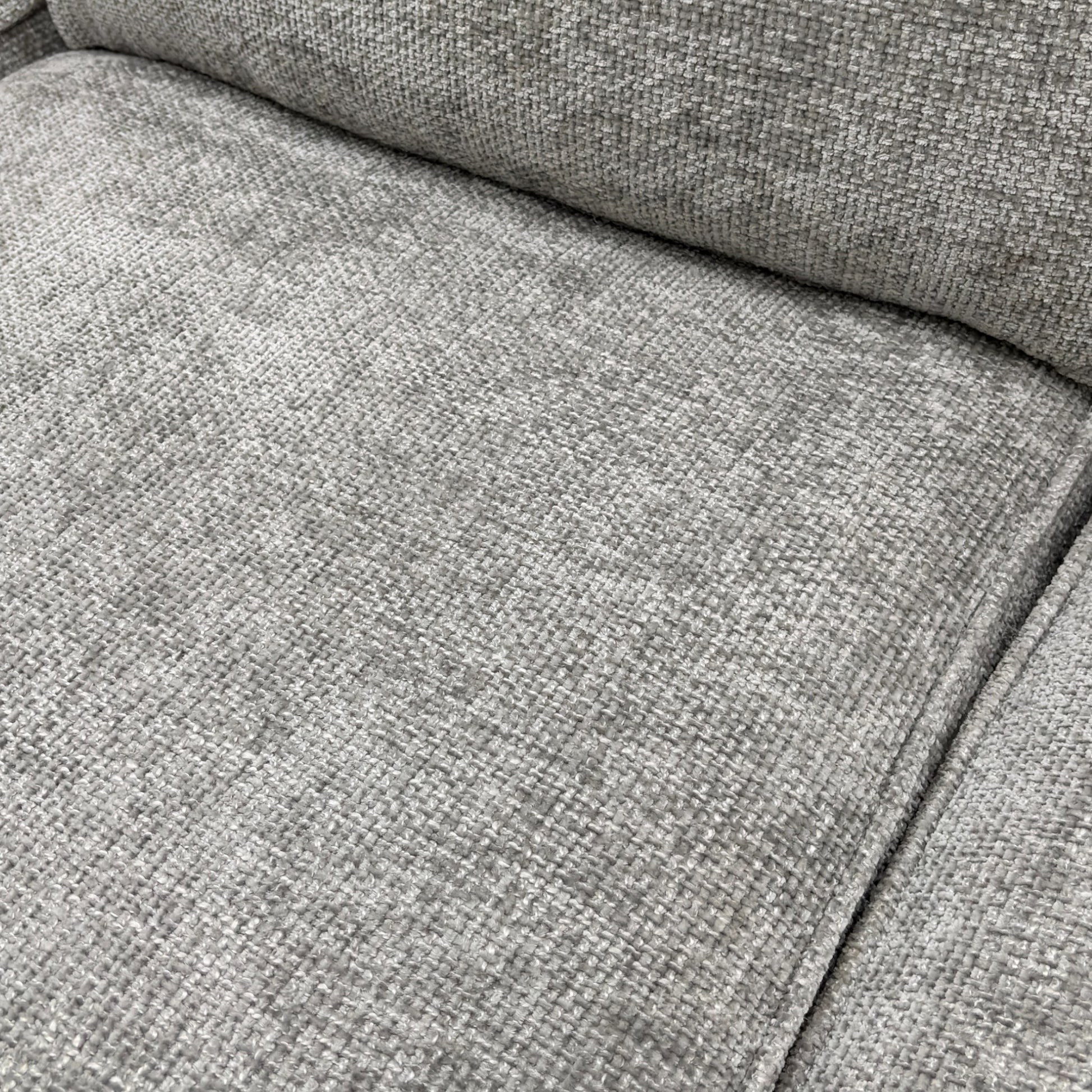 Close-up of the silver woven fabric, showing the fine texture and color of the 'Emilia' Corner Sofa Bed upholstery.