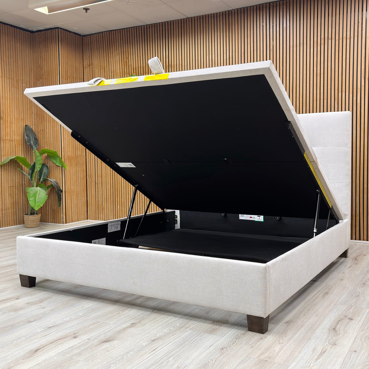 Life Style shot of the button-tufted headboard on the Hadley bed, showcasing the quality of the oatmeal fabric and traditional stitching.