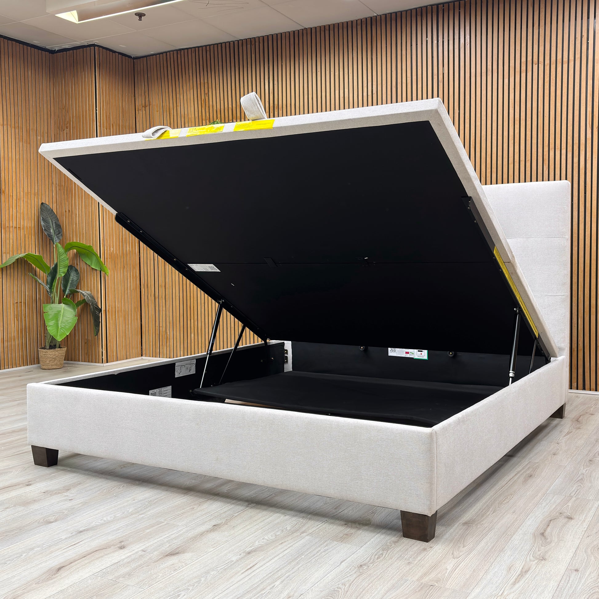 Life Style shot of the button-tufted headboard on the Hadley bed, showcasing the quality of the oatmeal fabric and traditional stitching.