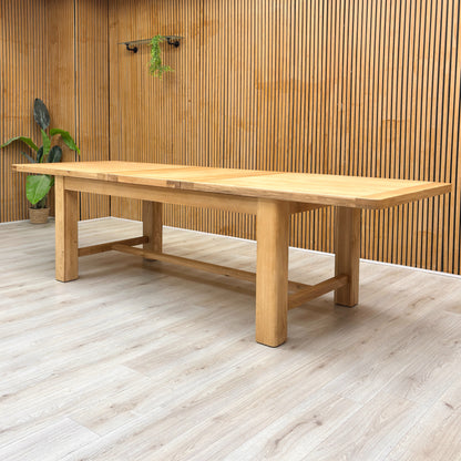 Lifestyle shot of the Augusta dining table in a modern dining room setting, showcasing its generous size and elegant oak finish.