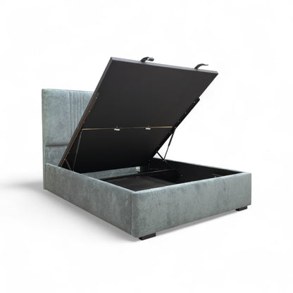 The King-size Ottoman Bed open, illustrating the functional end lift mechanism and the deep, full-size storage capacity beneath the mattress base.