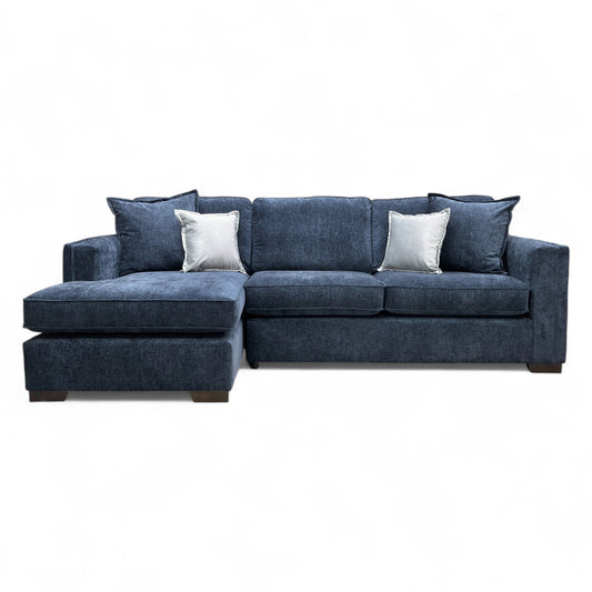 Angled view of the 'Chelsea' Navy Chenille Chaise, emphasizing the deep seating and the plush, textured finish of the fabric.