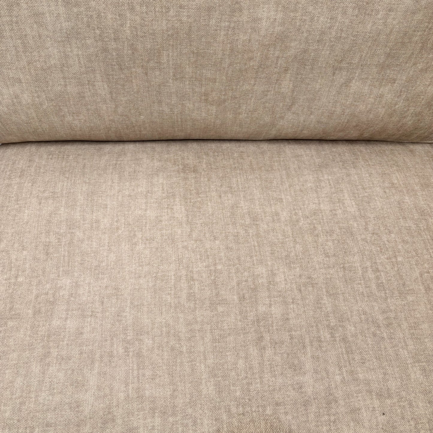 Close-up detail of the beige Vogue velvet upholstery on the 'Chelsea' sofa, showing the soft, textured fabric.