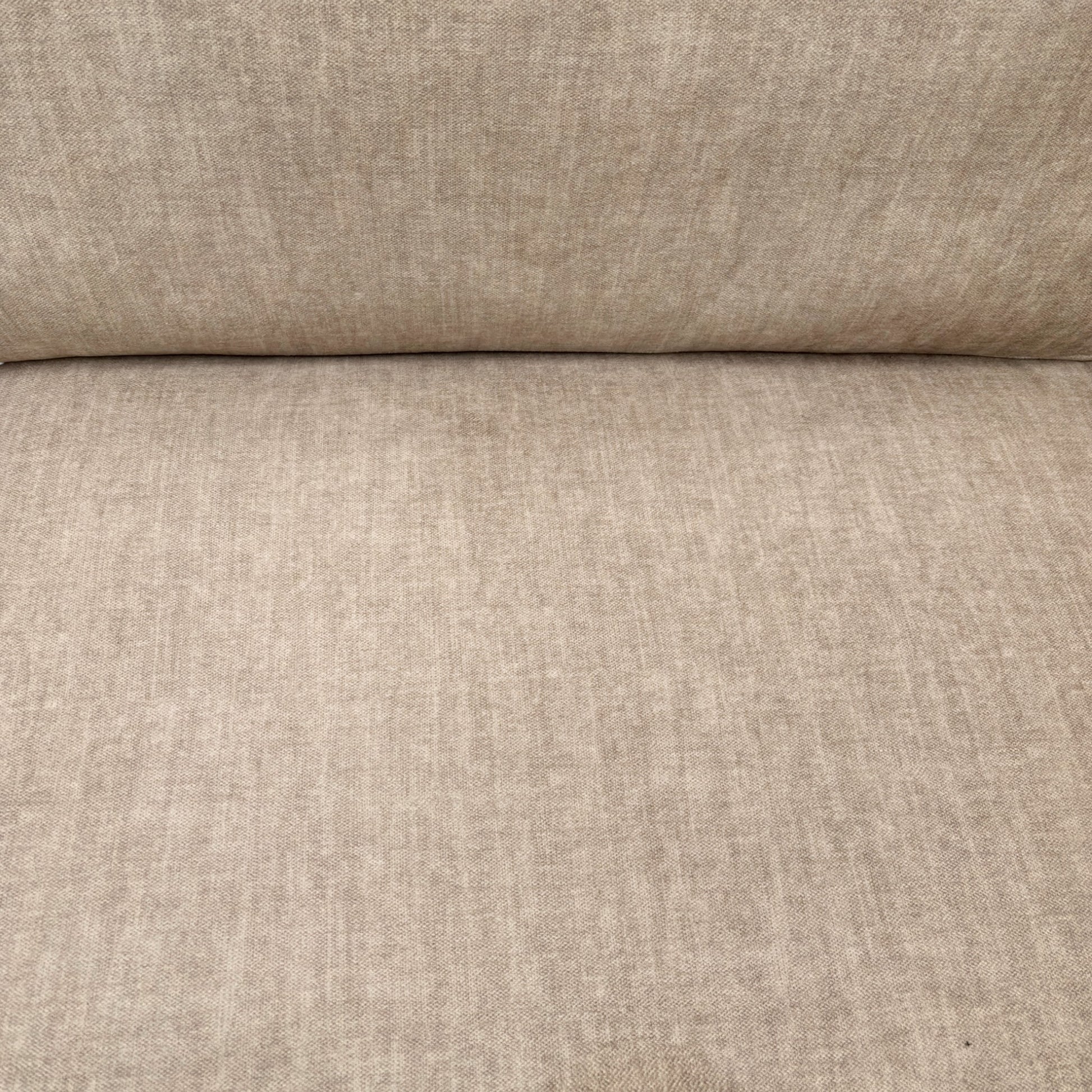 Close-up detail of the beige Vogue velvet upholstery on the 'Chelsea' sofa, showing the soft, textured fabric.