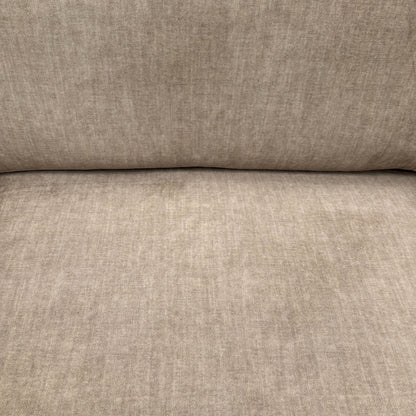 Close-up of the soft beige fabric upholstery of the Chelsea sofa, showcasing its luxurious texture and quality material.