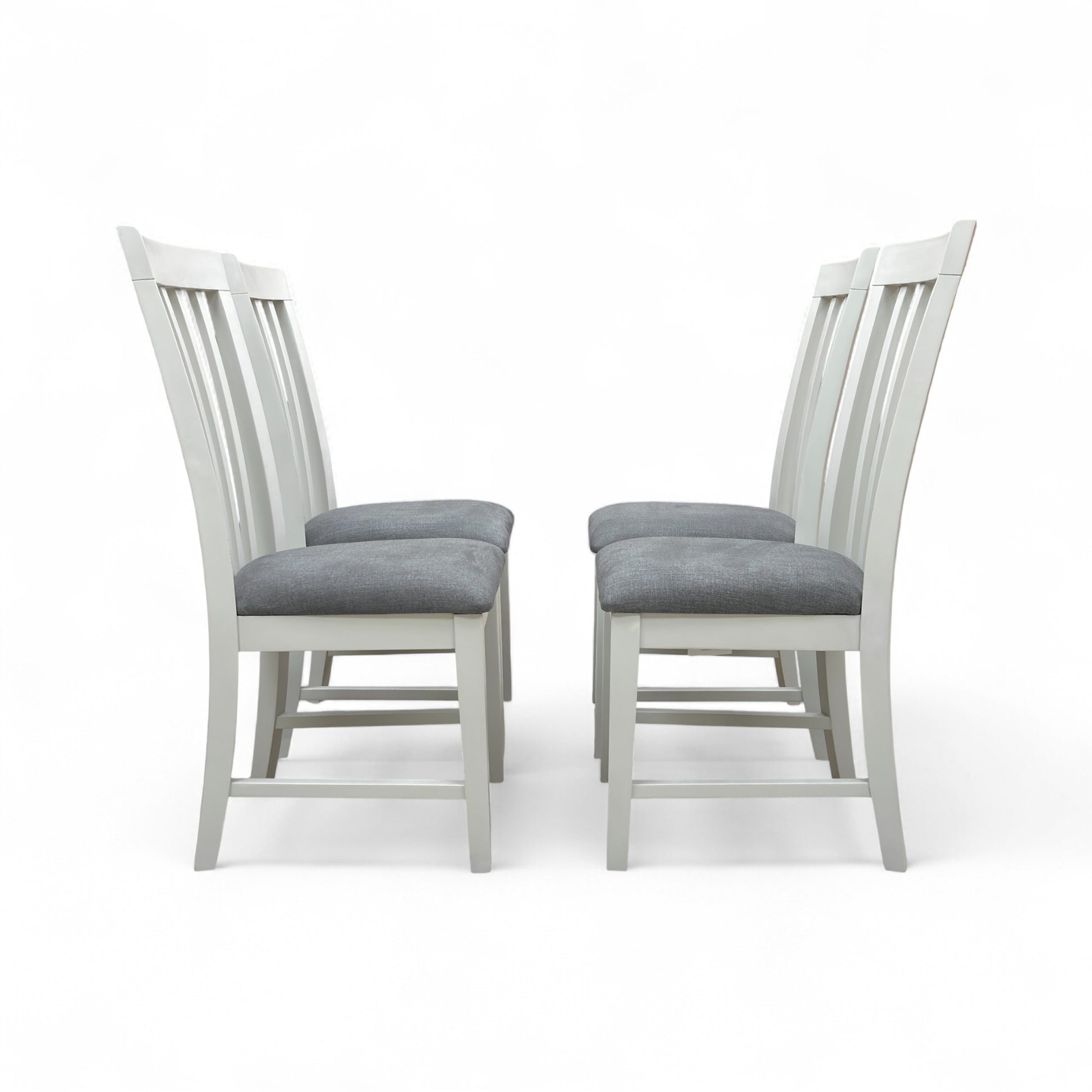 Angled view of the Hamilton grey wooden chair set, showing two chairs placed side-by-side, highlighting the craftsmanship and painted finish.