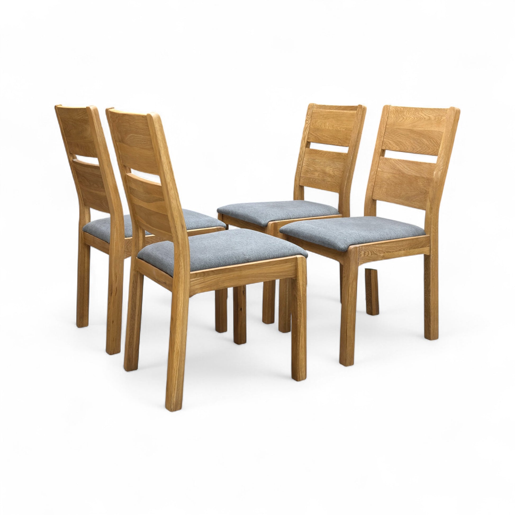 View of the back of the 'Bakerloo' dining chair, focusing on the solid wooden back panel and the finish of the legs.