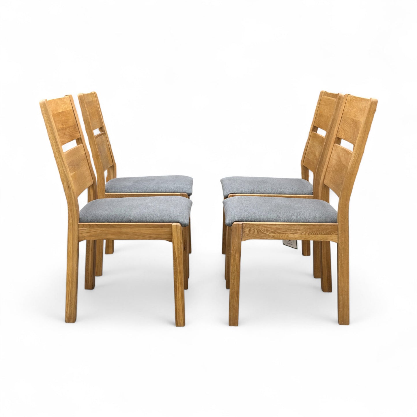 Angled view of the 'Bakerloo' chair, emphasizing the shape of the dark wooden backrest and the comfortable upholstered seat.