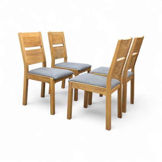 Front-facing view of the 'Bakerloo' upholstered dining chair, showing the dark fabric seat and the curved wooden top rail and frame.