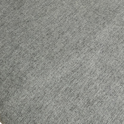 Close-up detail of the upholstered seat fabric and the junction with the dark wood frame on the 'Bakerloo' dining chair.