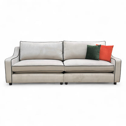 Front-facing view of the 'Celine' 4 Seater Split Sofa in Plush Platinum Velvet, featuring a sloped arm design and scatter cushions.