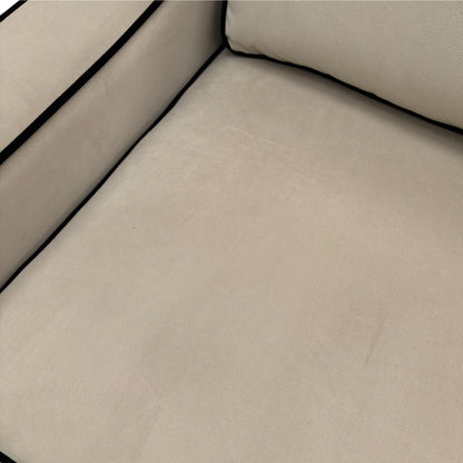 Close-up of the plush platinum velvet fabric upholstery, showing the soft, reflective quality of the material and the sofa's stitch detailing.
