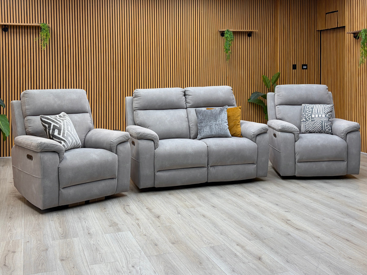 Raven Dexter stone grey velvet 2 seater power recliner sofa and two power chairs against a slatted wooden wall