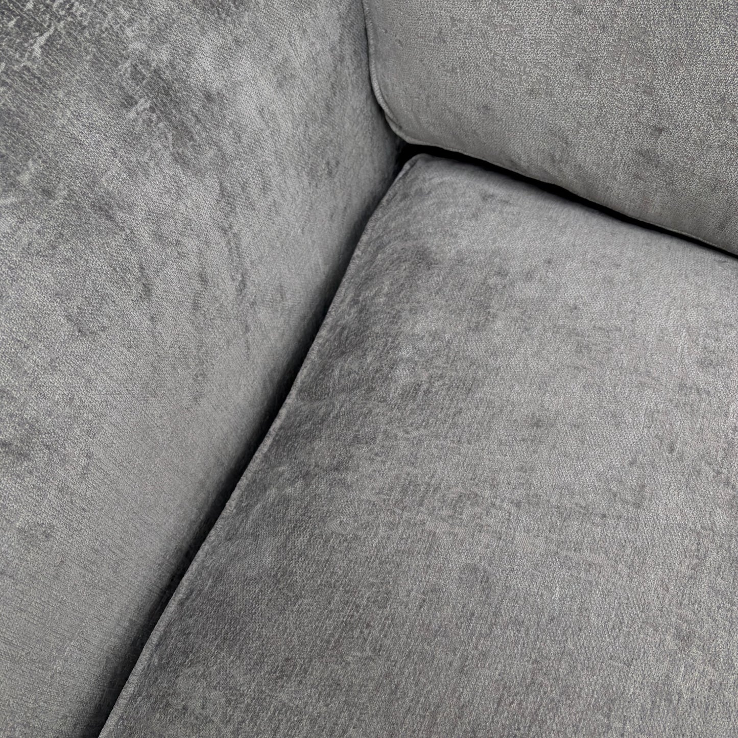 Close-up of the soft Shark Grey chenille fabric and cushion stitching on the 'Rosie' sofa.