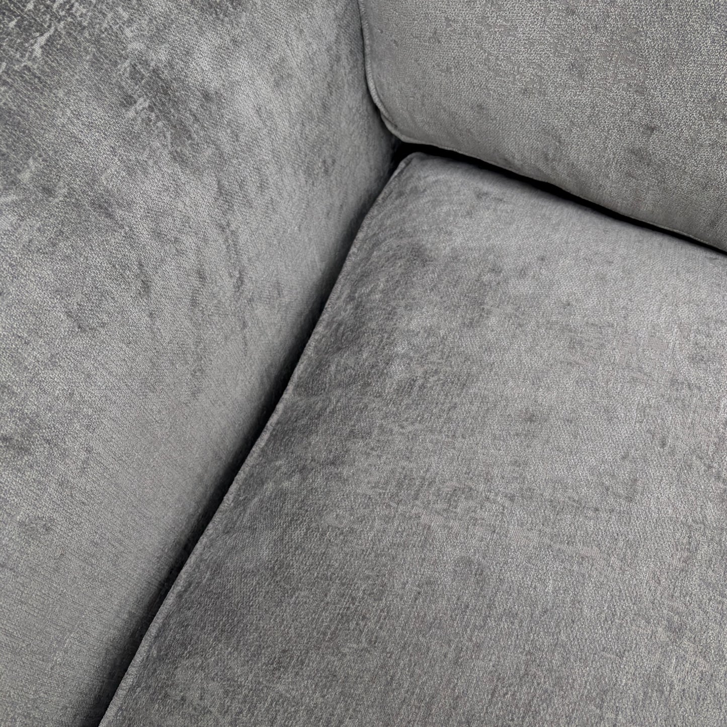 Close-up of the chenille fabric texture, stitching, or a cushion detail.