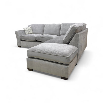 Detail shot showing the armrest, cushioning, and the contemporary wooden feet.