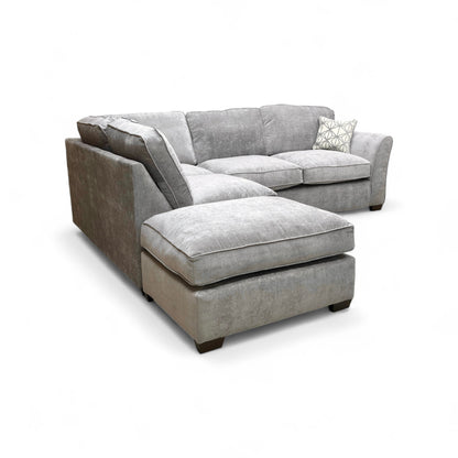 Detail shot showing the armrest, cushioning, and the contemporary wooden feet.