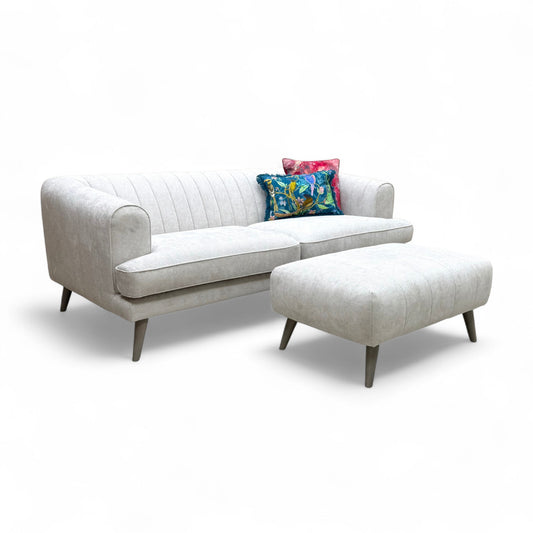 Full view of the Aurelia Taupe Catalina 4 Seater Sofa and the matching Bench Footstool set in a room setting.