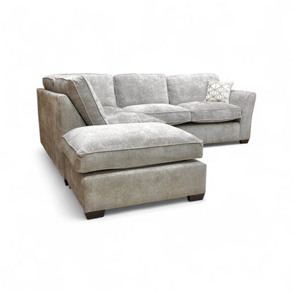 Side view of the sofa, focusing on the left-hand facing open-end chaise section, showing the seat depth and modern base.