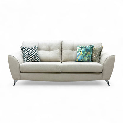 Full front-angled view of the long Dawson Wheat Plain 4 Seater Sofa, showcasing its large size and neutral wheat-colored fabric.