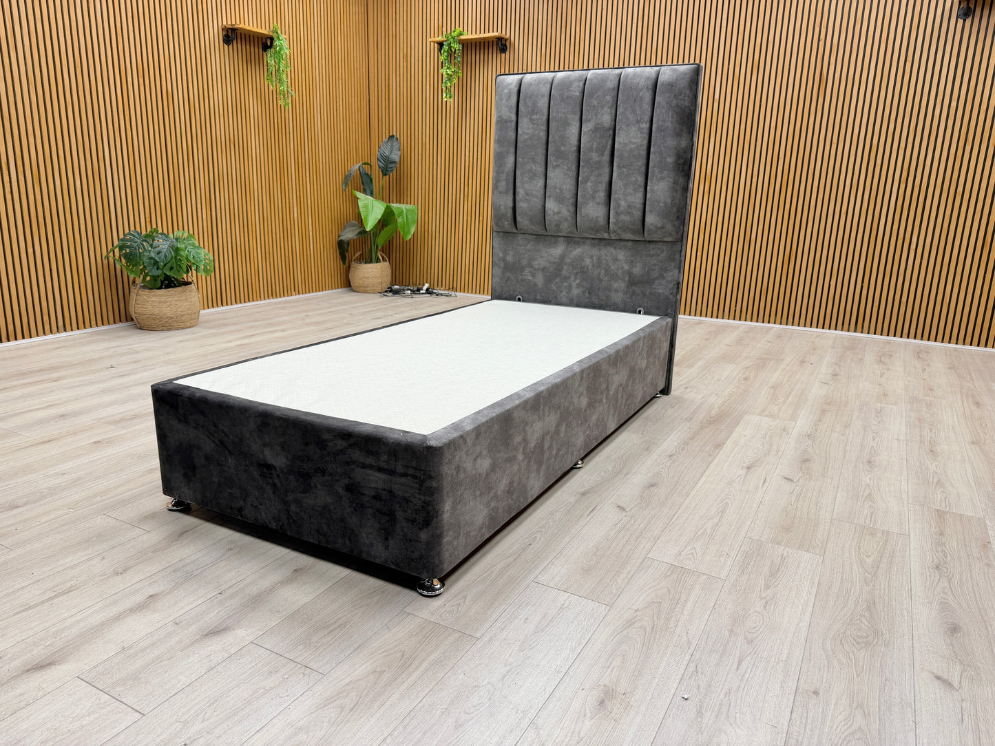 Detail view of the floor-standing headboard, showing the intricate domino-style lace patterns and plush velvet texture.