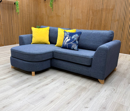 An angled view from the side, emphasizing the tapered arms and the overall depth of the sofa.