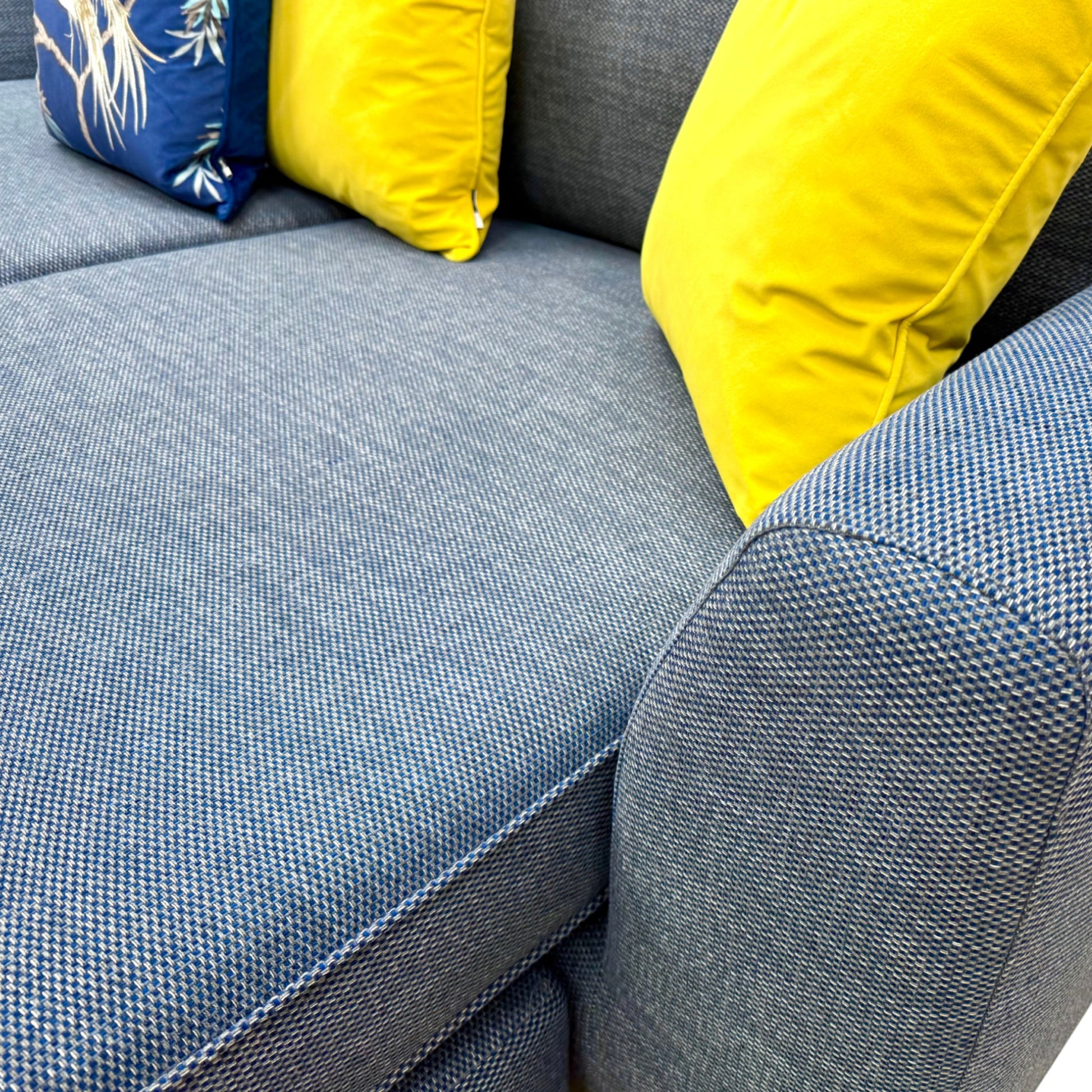 A close-up on the fabric or a specific part of the arm/base of the sofa.