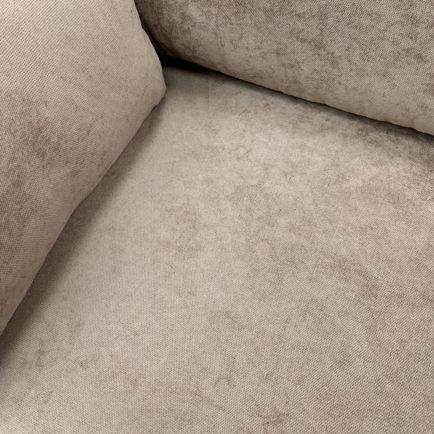 Close-up on the contemporary wooden feet and the bottom edge of the mink fabric sofa.