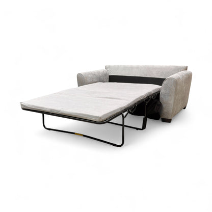 Side profile view of the ‘Julius’ sofa in its upright position, showing the depth and simple, modern wooden legs.