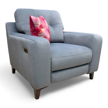 Low angle view of the 'Iris' steel grey velvet power recliner armchair, showing the base and profile.