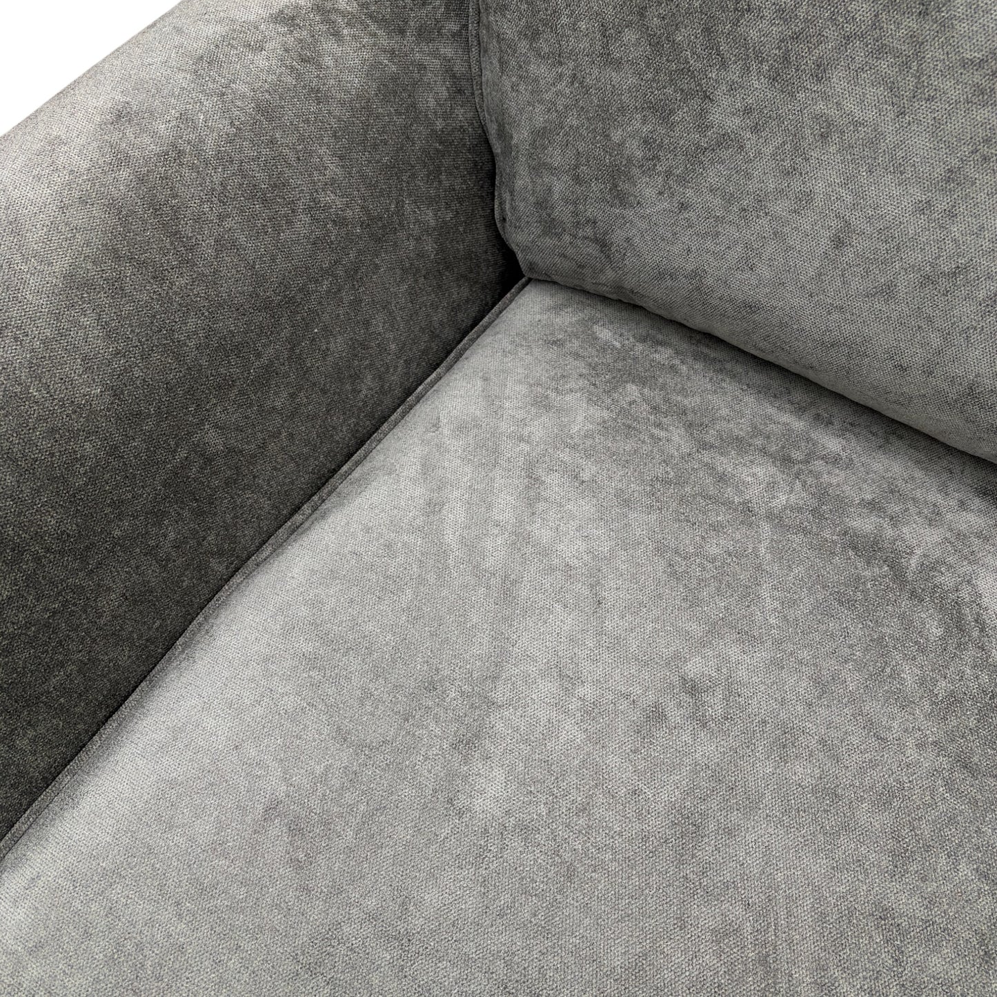 Close-up on the modern wooden feet of the grey fabric sofa.