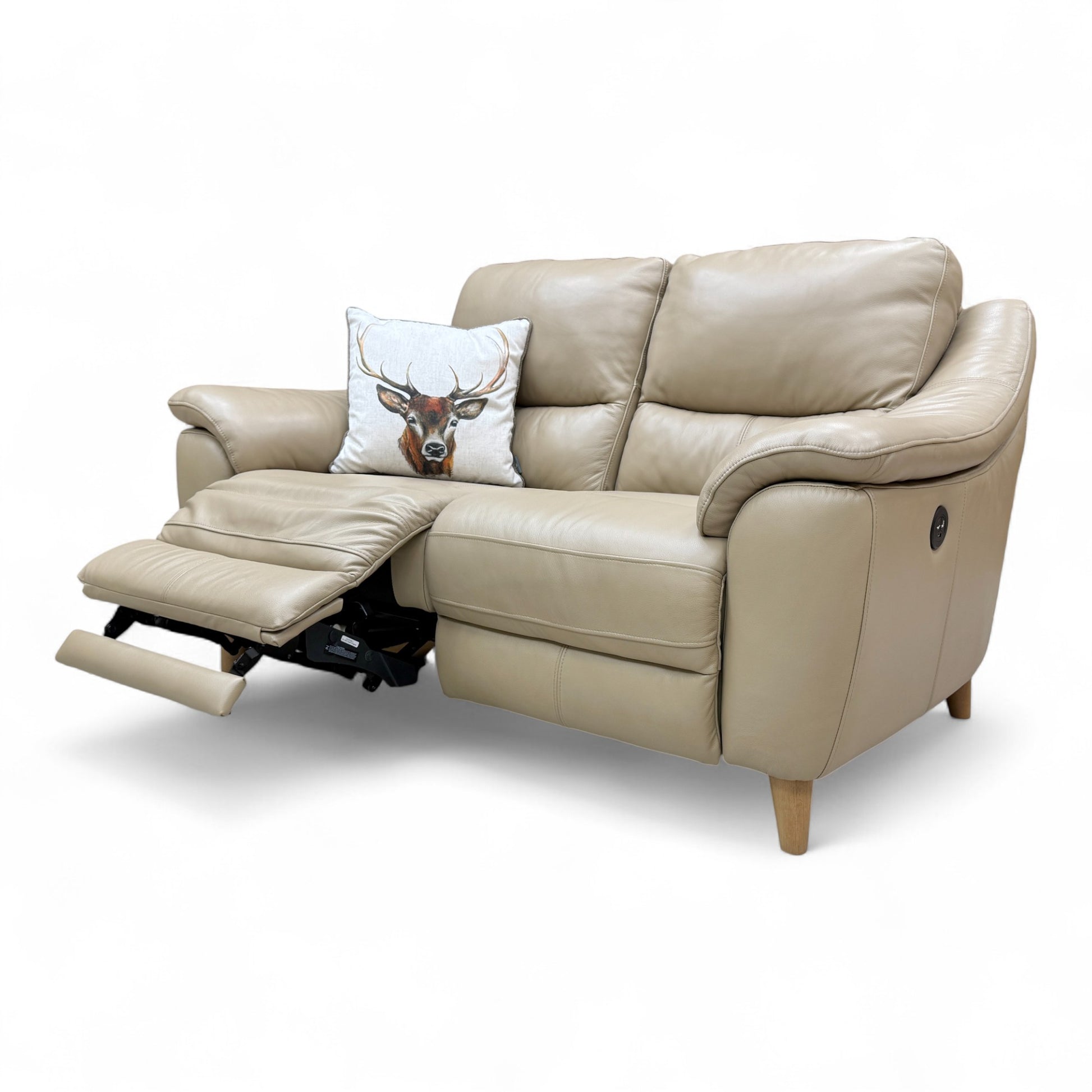 The 'Francis' cream leather 2-seater sofa fully reclined, with both footrests extended for maximum comfort.
