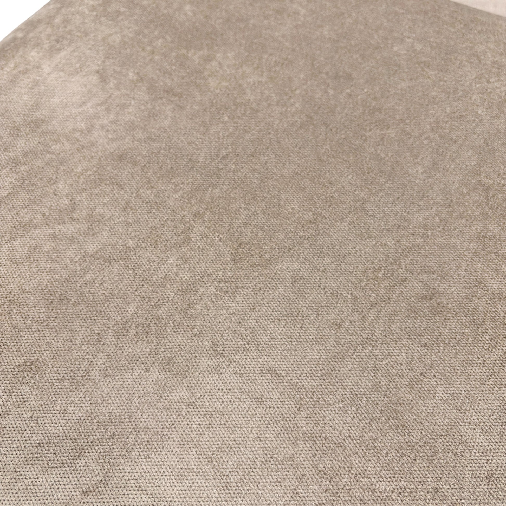 Close-up on the contemporary wooden feet and the bottom edge of the mink fabric sofa.