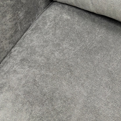 Close-up on the base and modern wooden feet of the grey fabric sofa.