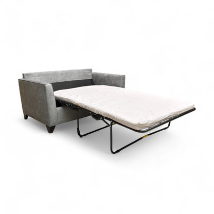 Detail shot of the grey Kingston fabric texture and stitching on the sofa.