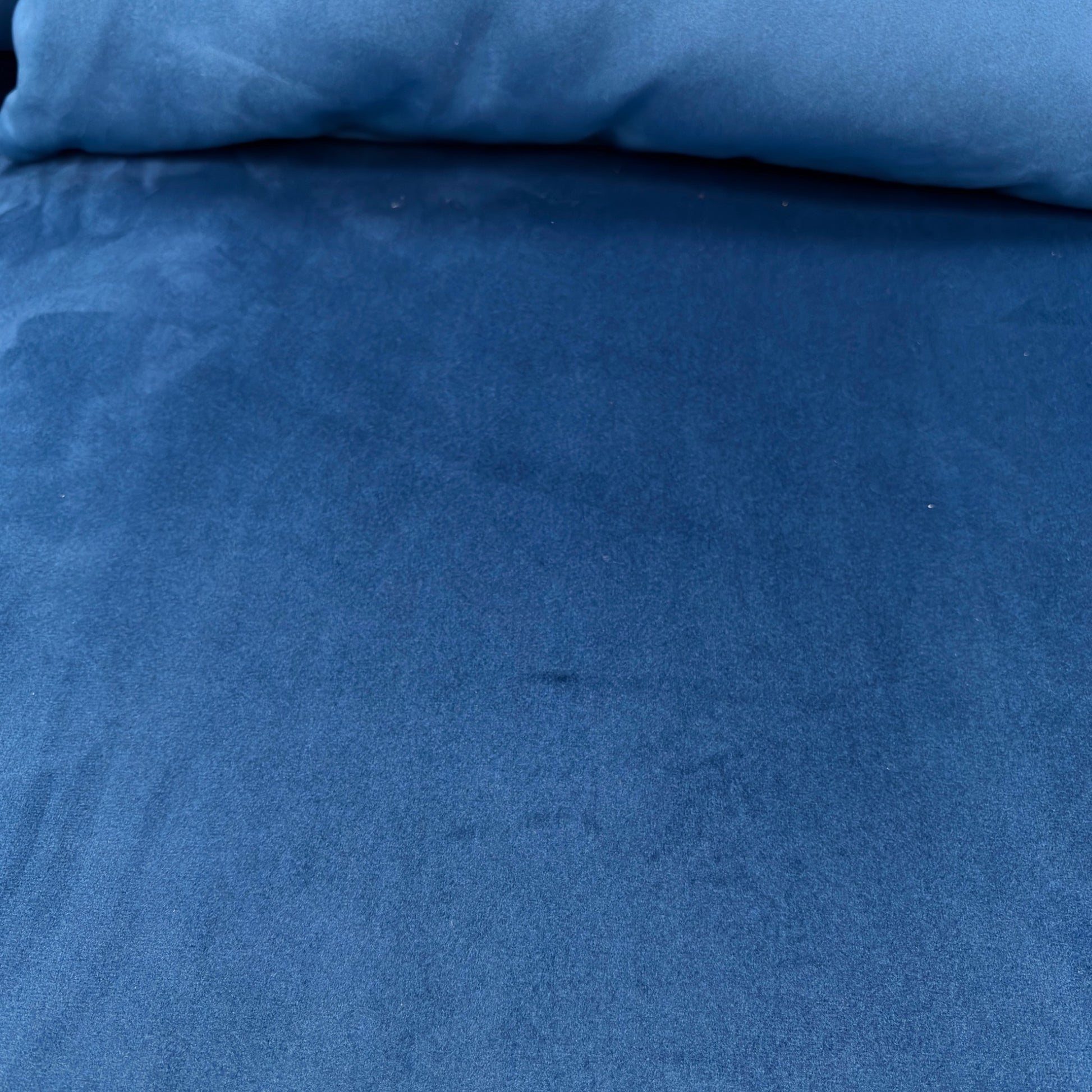 Close-up of the sensual velvet fabric texture, showing the rich dark blue colour and sheen.