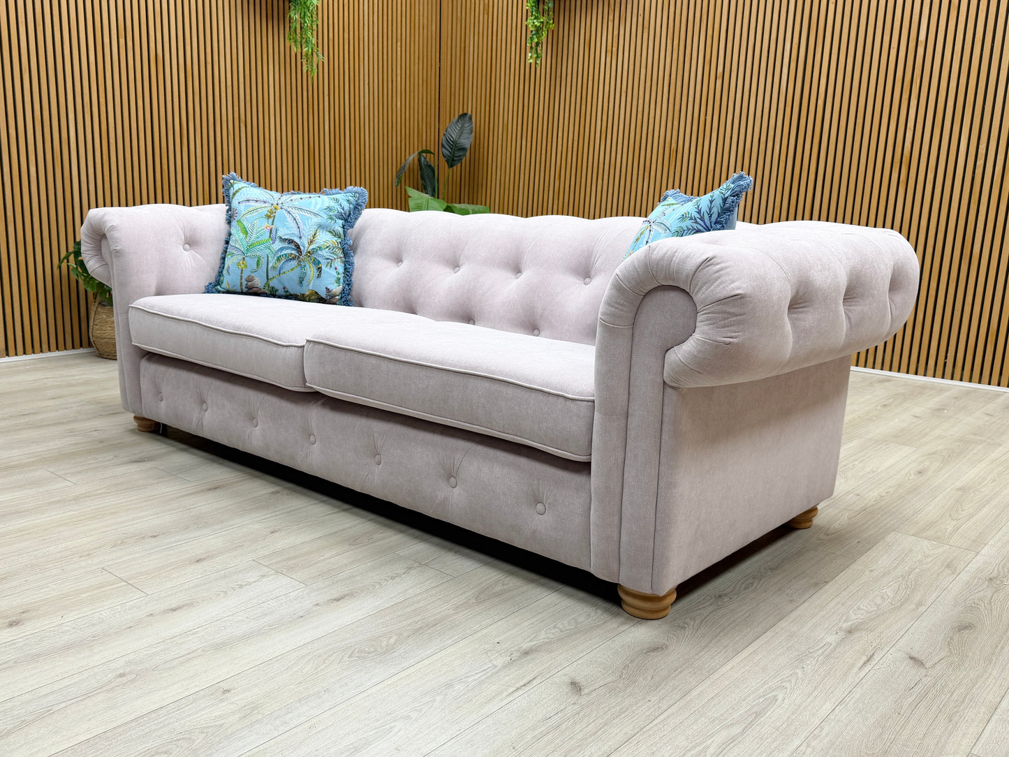 Side profile of the Belair Chesterfield, illustrating the depth of the seating and the refined curve of the rolled backrest.