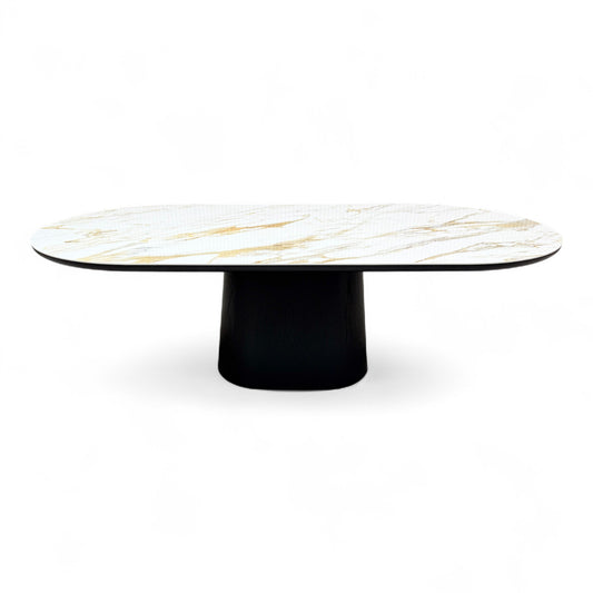 Side view of the 'Allegra' fixed dining table, emphasizing the rectangular ceramic top and the structure of the dark, angular smoked oak base.