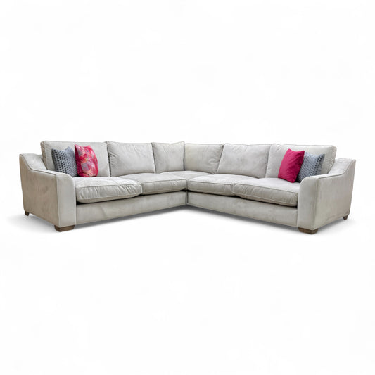 Full front view of The Lounge Co. 'Isobel' Stone Velvet Large 2 Corner 2 Sofa, showing the full corner configuration in a living room setting.